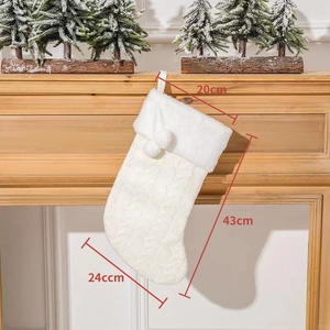 Close-up showing white knitted Christmas stocking dimensions: 20cm width and 43cm total length