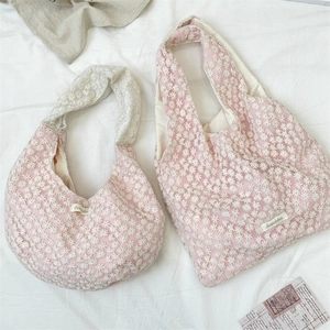 Flat lay of pink mesh canvas tote bags featuring delicate white daisy lace embroidery
