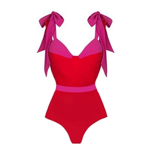 Women's red one-piece swimsuit featuring pink bow straps and a color-block waist belt