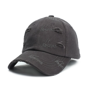 Detail of distressed dark grey baseball cap with Nefarious embroidery and worn holes