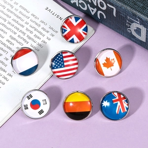Detailed view of assorted national flag badges with polished metallic edges and glossy finish