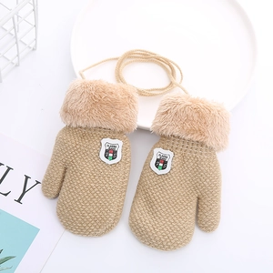 Close-up of camel knit children's gloves with fleece cuffs, neck string, and leather label