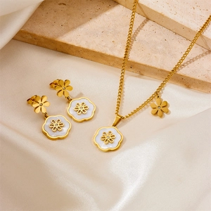 Golden flower jewelry set with white shell inlay necklace and earrings on silk