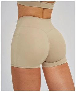 Detailed back view of high-waisted yoga shorts with V-shaped lifting seams and side pocket
