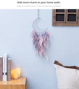 Detail of crescent moon dream catcher with purple and pink feathers and warm LED lights