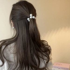Elegant pearl hair tie worn on brunette hair in a natural lifestyle setting