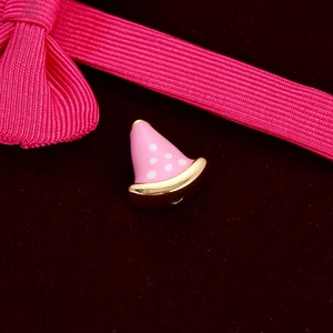 Pink polka dot cone bead with gold trim on red velvet for DIY jewelry making