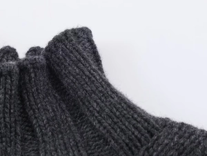 Macro detail of charcoal grey ribbed knit wool blend vest with thick texture