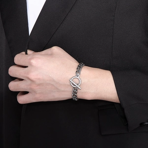 Polished stainless steel Cuban link bracelet with OT toggle clasp on a suit sleeve