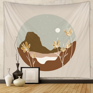 Detail of bohemian wall tapestry featuring minimalist mountain and moon landscape art