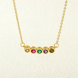 Close-up of gold chain necklace featuring five vibrant round-cut colored gemstones