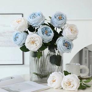 Realistic white and blue Austin roses in a ribbed glass vase for home wedding decor