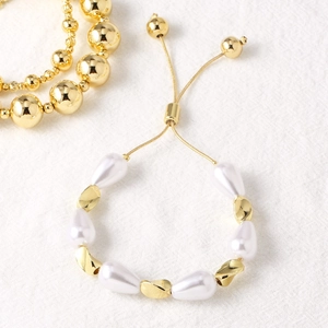 Elegant 18k gold plated pearl bracelet featuring teardrop pearls and spiral charms