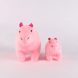 Close-up of large and small pink capybara plush toys showing soft texture and contrast