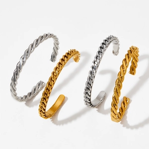 Detailed view of polished twist rope and chain-link cuff bracelets in gold and silver