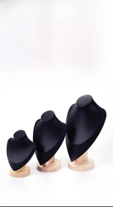Three-piece black leather bust necklace display stands with light wood bases in tiered sizes