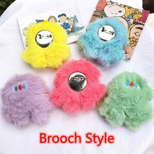 Plush octopus monster brooches in five colors on a textured white surface for bags