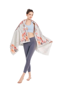 Detail of soft microfiber beach towel showing floral print and hem stitching in use