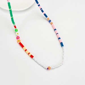 Close-up of colorful handmade beaded phone strap with flower and smiley face charms