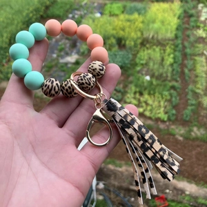 Close-up of silicone beaded keychain with leopard print tassel and gold ring