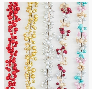 Detailed view of colorful Christmas ball garland strings in red, gold, and silver finishes