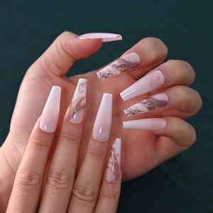 Detailed view of long coffin press-on nails with pink purple marble and gold glitter lines