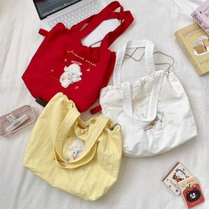 Detailed view of colorful canvas tote bags with drawstring and cute dog embroidery