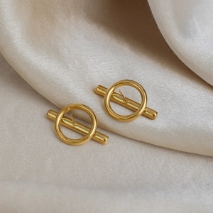 Minimalist 18K gold plated irregular geometric stud earrings on beige silk fabric