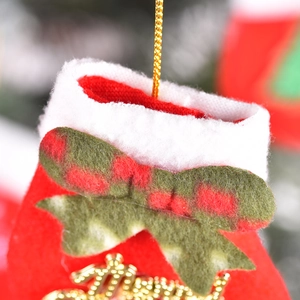 Red Christmas stocking gift bag with white plush cuff, green bow and golden greeting