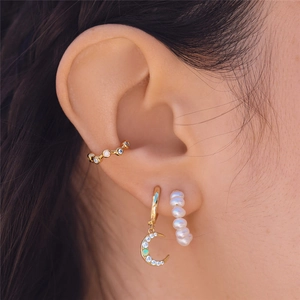 Detailed close-up of S925 silver moon earring set with baroque pearl and zircon