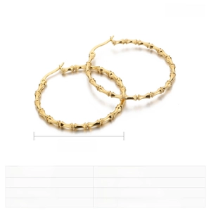 Detail showing 40mm bamboo pattern hoop earrings in gold finish stainless steel
