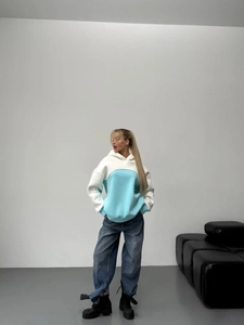 Relaxed color-block drawstring hoodie with wide-leg jeans in a minimalist street style