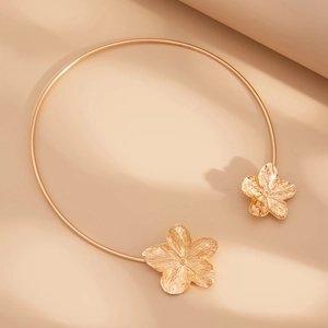 Elegant gold metal choker necklace featuring detailed flower petals on open ends