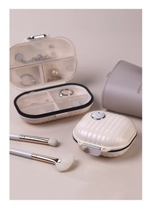 Internal view of mini portable cream jewelry box with compartments and suitcase design
