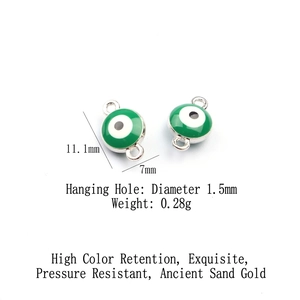 Detail view of green evil eye alloy pendants showing dimensions 11.1mm height and 7mm width