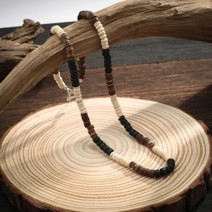 Bohemian men's necklace with coconut shell and wood beads on a natural driftwood base