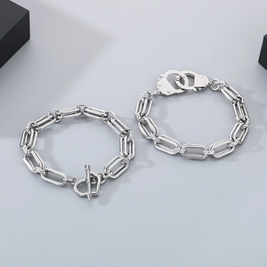 Detail of silver stainless steel double layer bracelets with heart OT and handcuff clasps