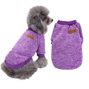 Detail of warm purple knitted pet sweater featuring a leather label on a toy poodle