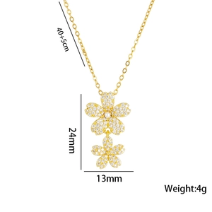 Golden flower tassel necklace with pearls and zircon crystals on a white background