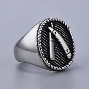 Detailed macro view of vintage stainless steel signet ring with razor relief pattern