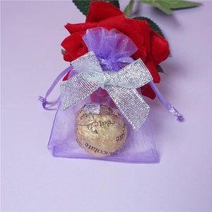 Purple organza drawstring gift bag with a silver ribbon bow for jewelry and candy