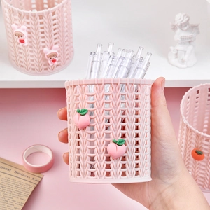Pink woven plastic pen holder with cute peach charm for desktop stationary storage