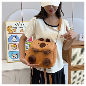 Detailed view of a soft brown plush capybara backpack with adjustable shoulder straps