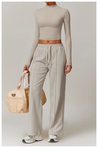 Detail of high-stretch mock neck long sleeve crop top with matching wide leg yoga pants
