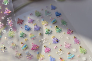 Detailed relief Christmas nail stickers featuring embossed trees and snowflake designs