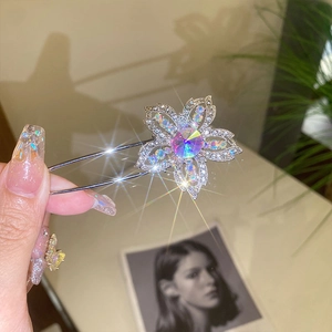 Macro shot of silver alloy flower brooch with aurora crystal and colorful rhinestones