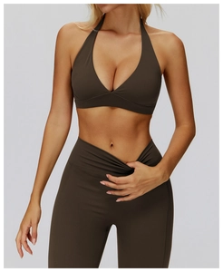 Detail of dark brown halter-neck sports bra and crossover high-waisted yoga pants