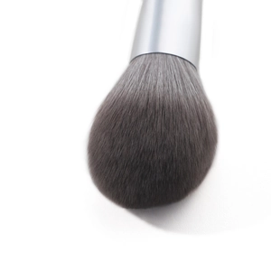 Macro shot of fluffy synthetic fiber brush head with silver metal ferrule on white background