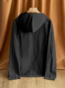 Detail of black cotton linen hooded shirt texture showing natural fabric folds on hanger