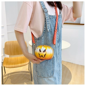 Detail of pumpkin-shaped crossbody bag in orange-yellow gradient with matching strap